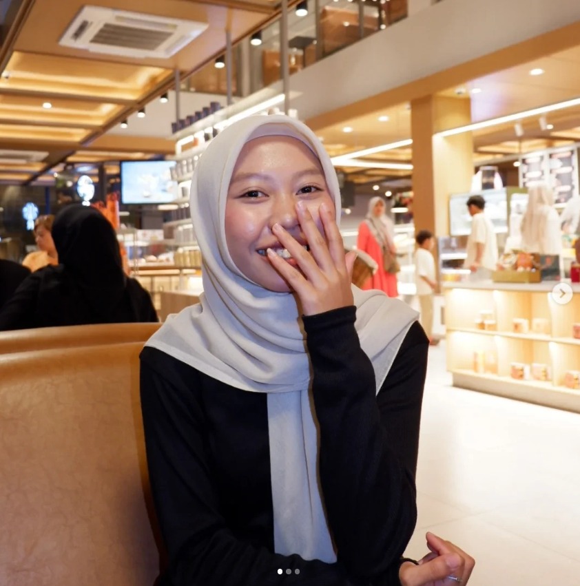 Milaa laughing in a cafe